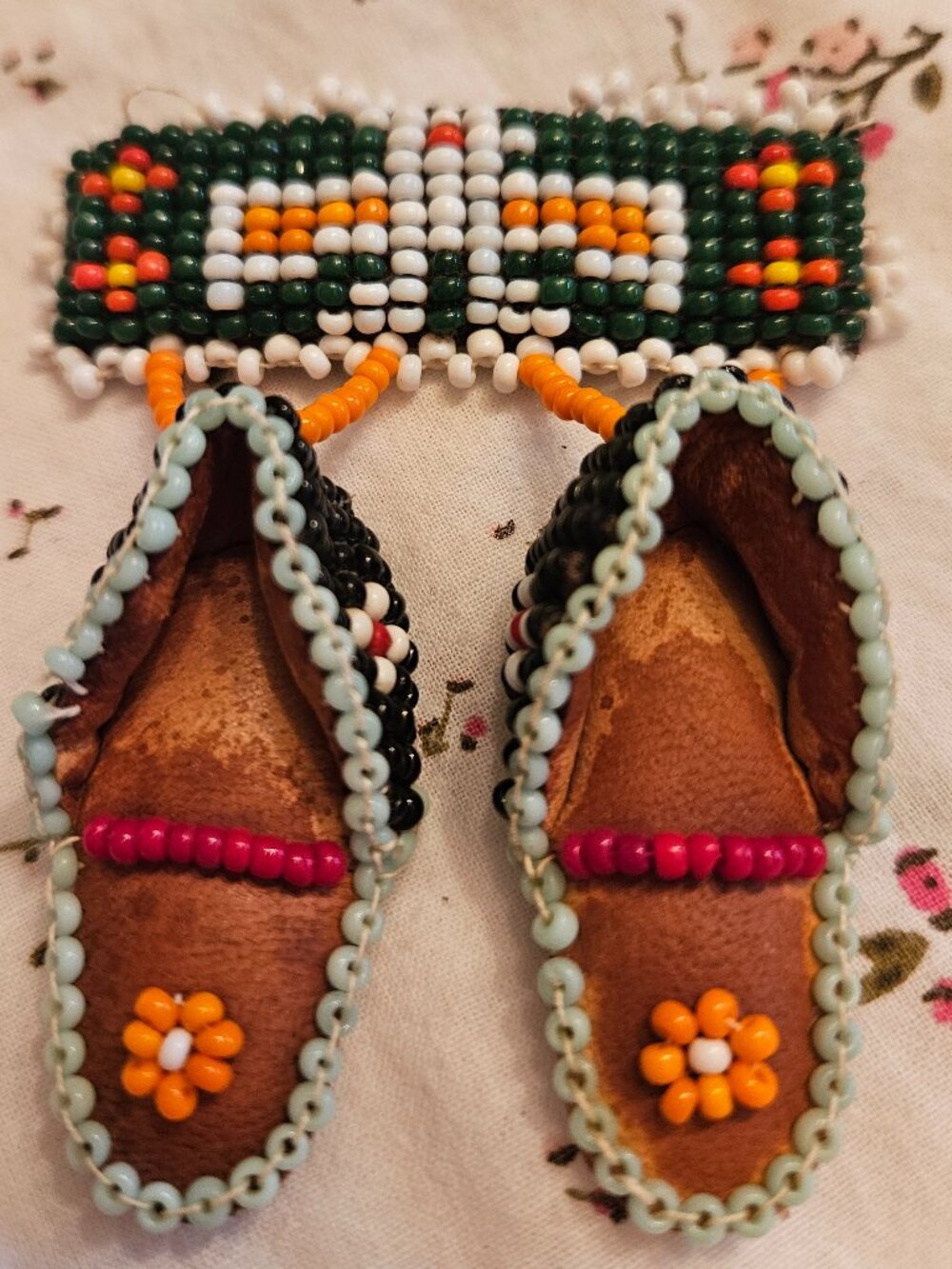 Indigenous leather beaded pin moccasins and Thunderbird